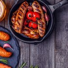 man holds burger with hands and sweet potato fries