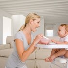 Little Girl Eating in High Chair