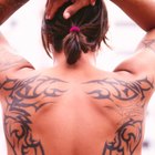 Close up of tattooed woman' || chr(39) || 's arm with Pacific Ocean in background in Maui, Hawaii, USA.