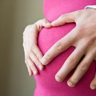 Woman lifting shirt and touching stomach