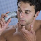 Man using electric shaver