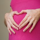 pregnant woman practicing yoga and fitness at home