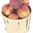 Fresh organic peaches in wooden crate viewed from above