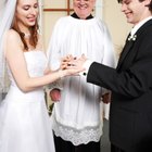 Groom putting a ring on bride's finger