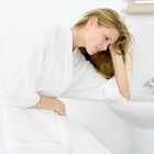 Stressed young woman sitting in bathroom