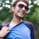 Portrait of smiling tattooed man with arms crossed