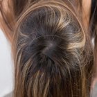 high angle view of a woman piling her hair up into a bun