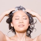 Woman shampooing hair and smiling