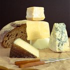 Woman Slicing Cheese in a Delicatessen