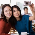 Women posing with pet dog at party in condominium