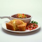 Corn bread cut in squares on baking paper, peanut butter