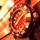 Mid adult man standing at street, looking at watch