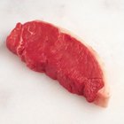 Dry aged raw beef steak with ingredients for grilling