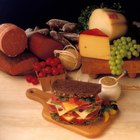 Cheese with herbs on chopping board