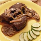 Grilled beef liver kebabs on a dark wooden background