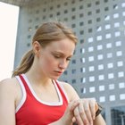 Woman looking at wristwatch in sports attire