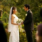 Groom placing ring on brides finger