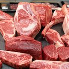 A slab of beef and onions on a baking tray