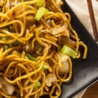 People sharing noodles, close-up