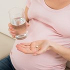 Pregnant Woman Holding Medicine At Home