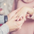 young woman with fiance showing her engagement ring