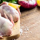 Fresh organic quails on vintage wooden table, healthy food