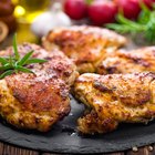 Roasted chicken on wooden plate