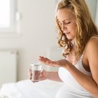 Young beautiful pregnant woman smiling on the background landsca