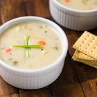 Potato soup in a bowl topped with bacon and cheddar cheese