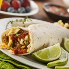 Freezer-friendly breakfast burritos on a plate with side dish of salsa