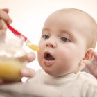 Unhappy baby boy refusing to eat food.