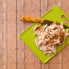 Tray of uncooked chicken breasts, thighs and legs with garnishes