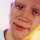 Woman having ear piercing process with special equipment