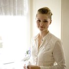 Pregnant woman looking at bathroom mirror