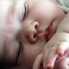 Newborn baby sleeping on the bed