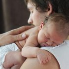 Pregnant woman lying down talking to her doctor