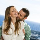 Man kissing smiling woman on cheek
