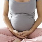 Cropped pregnant woman with blue booties