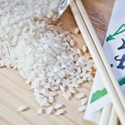 Unpolished rice on wooden background
