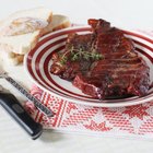 Cuts of warm, pink roast beef on a wooden surface