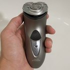 Man using electric shaver