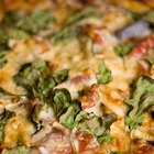 Cauliflower pizza crust with tomato and spinach