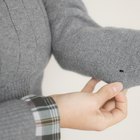 Close-up of teenage boy (16-17) wearing a hooded shirt