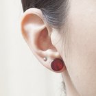 Woman trying on earrings in store