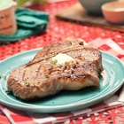 Butcher cutting beef meat on a wooden table