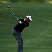 Tiger Woods prepares to attack the ball, using a properly shallow downswing.
