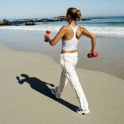 Walking on a beach with dumbbells can be good or bad.