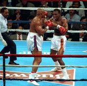 George Foreman, left, beat Evander Holyfield for the heavyweight crown at 42.