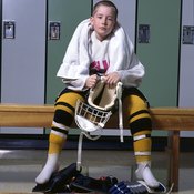 Players suit up in the dressing rooms before a hockey game.