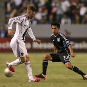 Rafael Baca of the San Jose Earthquake maintains his position against the speedy David Beckham of the L.A. Galaxy.